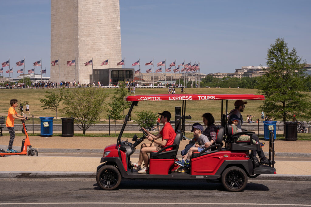 Family in Golf Cart in front of Washington Monument. Photo Taken by Ted Everett