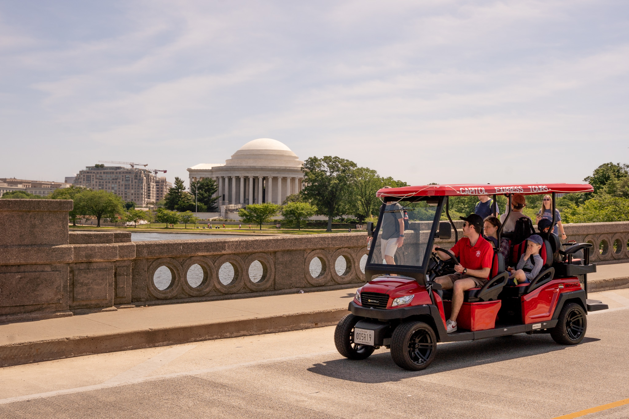 Family in Capitol Express Tours Golf Cart going over Tidal Basin with Jefferson Memorial in the background. Photo taken by Ted Everett
