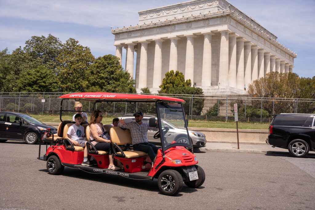 Family in golf cart on tour in front of Lincoln Memorial. Photo taken by Ted Everett